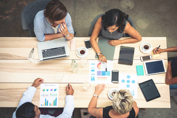 istock Teamwork in start-up office with several coworkers 897668560