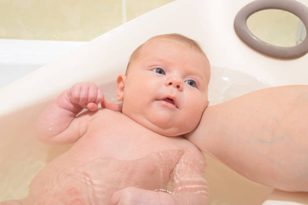 istock Baby-girl takes a bath 897671532