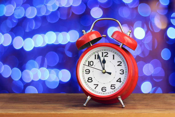 istock Red retro alarm clock at twelve o'clock. 897681252