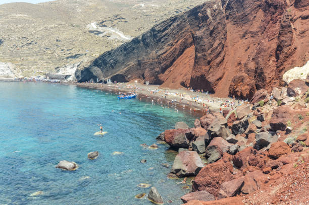 istock Visitors enjoy the unique Red Beach in Santorini, Greece 897697780