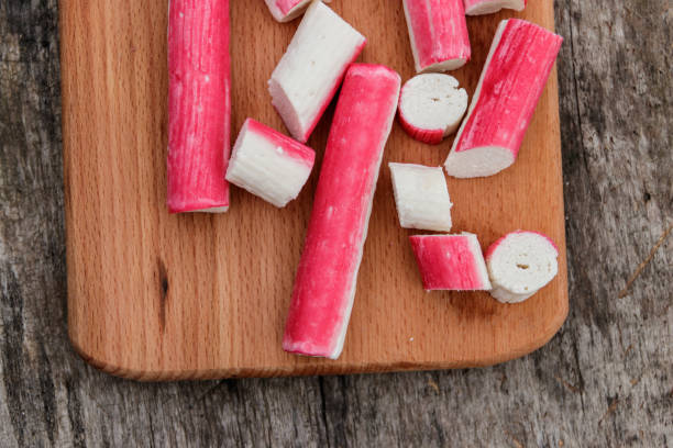 istock Crab sticks on cutting board on rustic wooden table 897697838