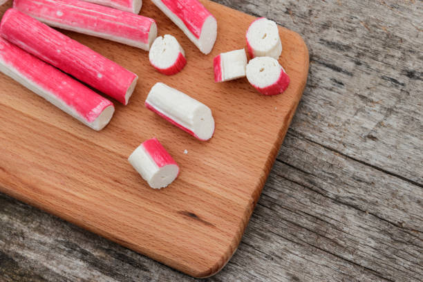 istock Crab sticks on cutting board on rustic wooden table 897697854
