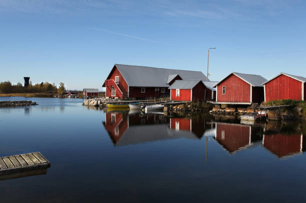 istock Red houses by the lake 897710832