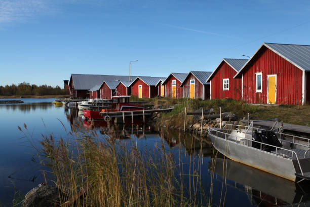 istock Red houses by the lake 897710840