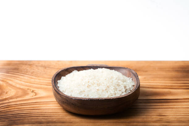 istock Raw rice on wood desk 897713976