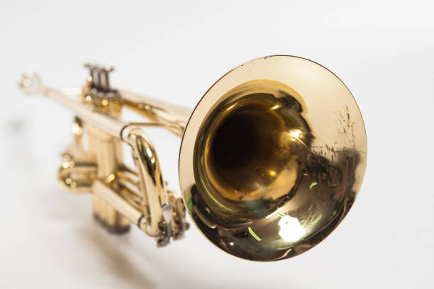 Gold lacquer trumpet with mouthpiece isolated on white Gold lacquer trumpet with mouthpiece isolated on white trumpet player isolated stock pictures, royalty-free photos & images