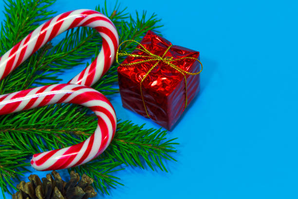 istock Christmas candy on the branches of a Christmas tree with a gift box 897716890