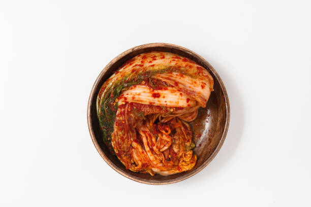 istock Kimchi in a wooden bowl isolated 897717486