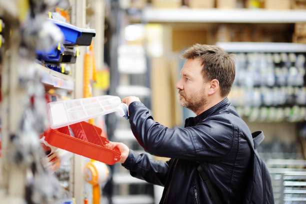 istock Middle age man choosing the right tool box in a hardware store 897723808