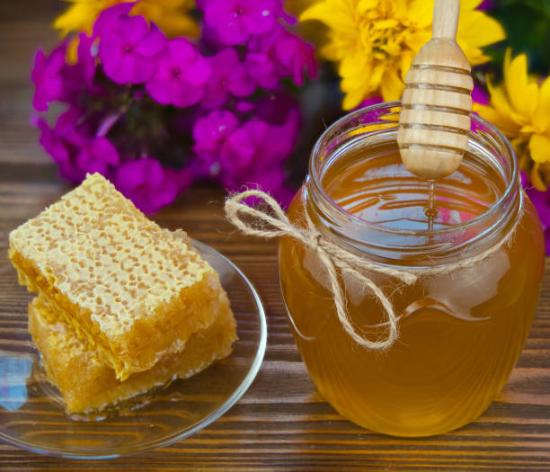 istock Delicious delicious honey in  jar on table 897745398