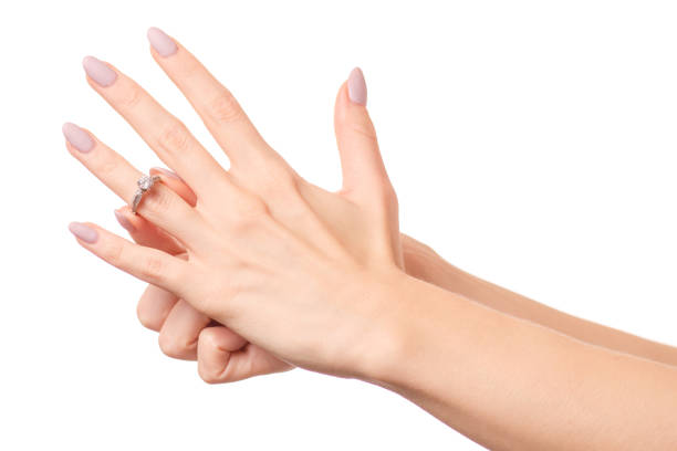 istock Female hand holding a silver ring  white gold 897745588