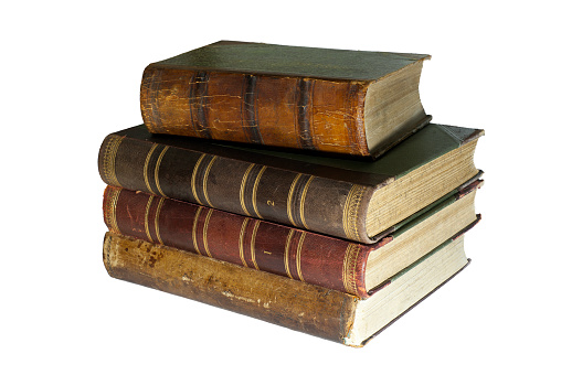 A stack of four ancient books isolated