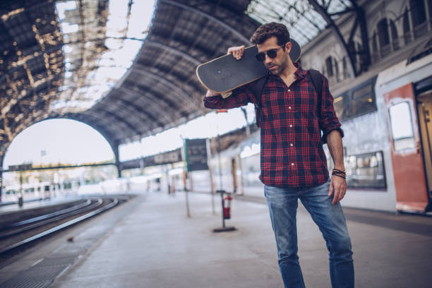 istock Handsome skater on train station 897748926