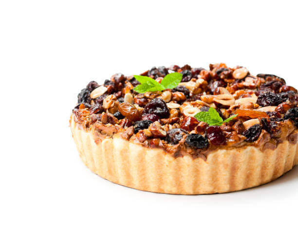 istock Delicious  tart with dried berries and nuts isolated on white 897748994