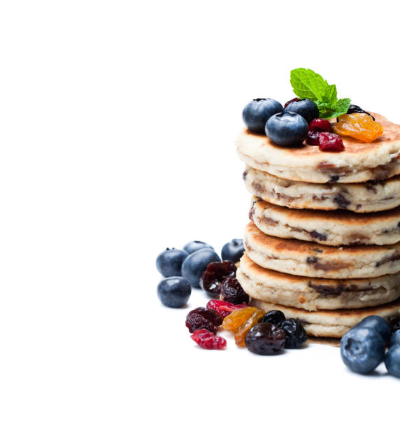 istock Stack  of welsh cakes with dry berries and fresh blueberries isolated on white 897751080