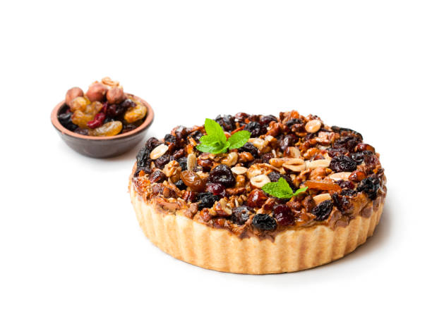 istock Delicious  tart with dried berries and nuts isolated on white 897755558