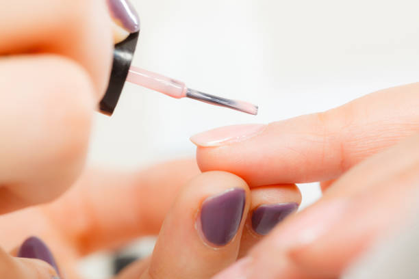 istock Woman in beauty salon getting manicure done. 897765076