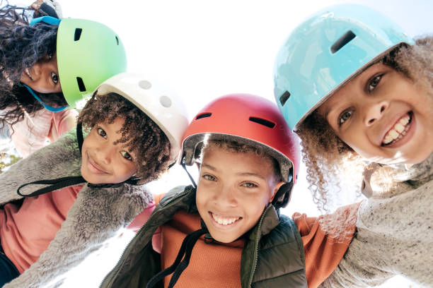 10-12 years old siblings with helmets having fun outdoor - 10 11 years cheerful happiness fun imagens e fotografias de stock