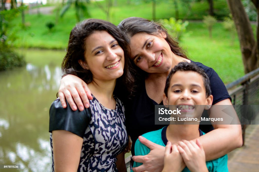 Mother, daughter and son Family smiling in public park girl, boy and woman, mother, daughter and son Brazil Stock Photo