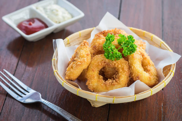 istock Fried calamari rings in wicker basket and sauce 897811652