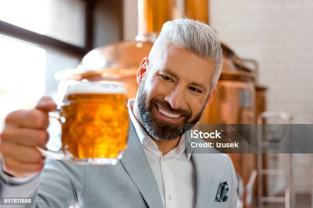 Smiling Microbrewery Owner Holding A Beer Mug In His Pub Stock Photo - Download Image Now