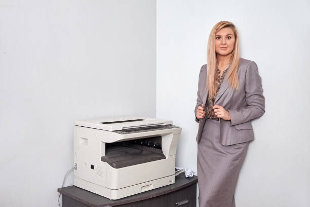 istock Businesswoman working on a copy machine at the office 897826946