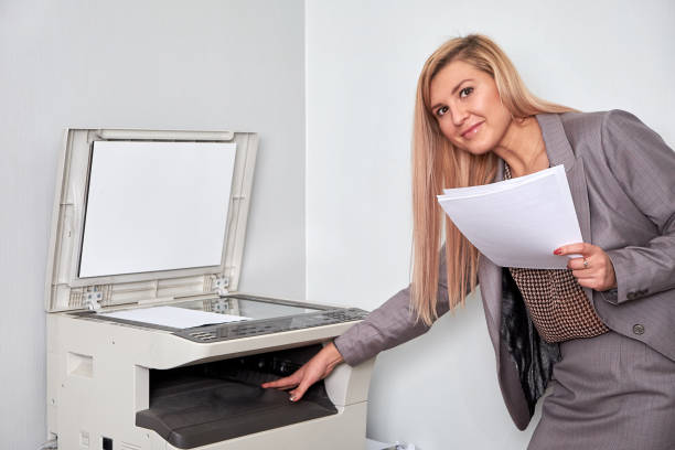 istock Businesswoman working on a copy machine at the office 897827170
