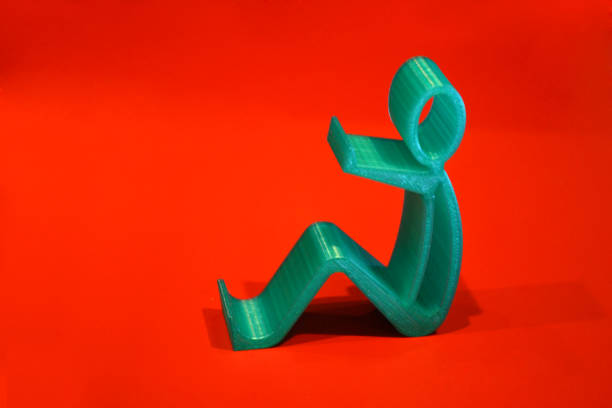 istock Abstract isolated object of a green color printed on a 3d printer on red surface 897835112
