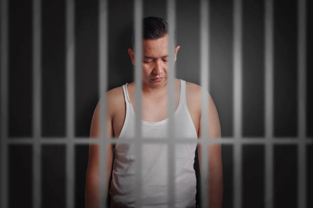 istock Young man locked in jail 897839368