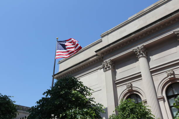 istock American flag and white building in New York 897842664