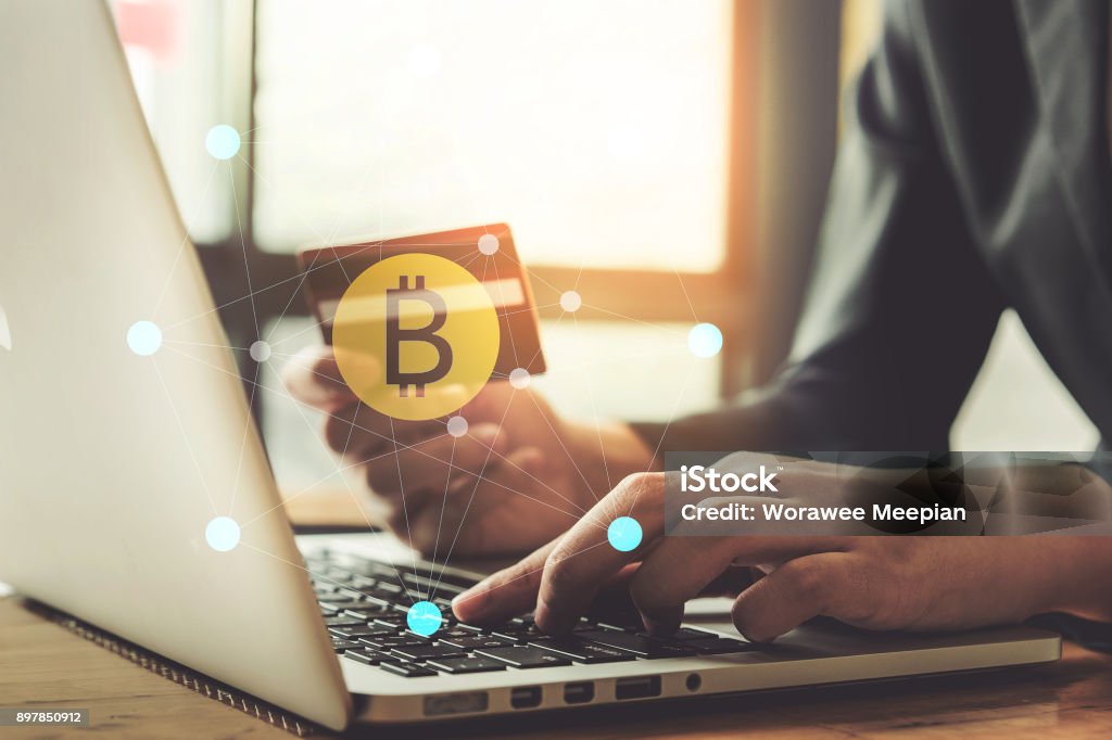 internet banking network and cryptocurrency concept. Man hand using credit card for trade cryptocurrency. Cryptocurrency Stock Photo