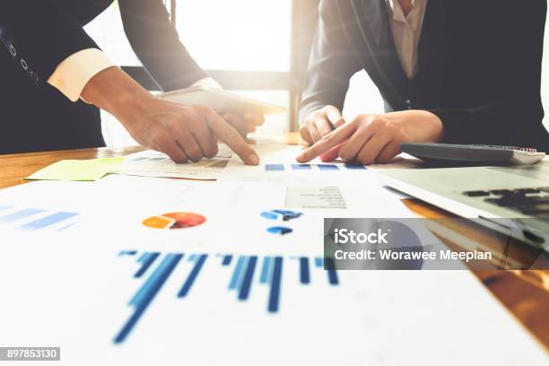 Close Up Of Business Man Hand Pointing At Business Document On Financial Paper On Wooden Desk During Discussion At Meeting Group Support Concept Stock Photo - Download Image Now
