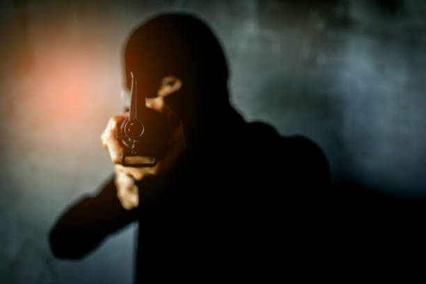 istock robber, Thief Criminal holding gun concept, Robber with masked and weapon. 897858570