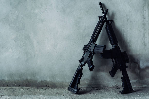 double assault rifle on gray background, terrorist,robber concept. - armamento imagens e fotografias de stock