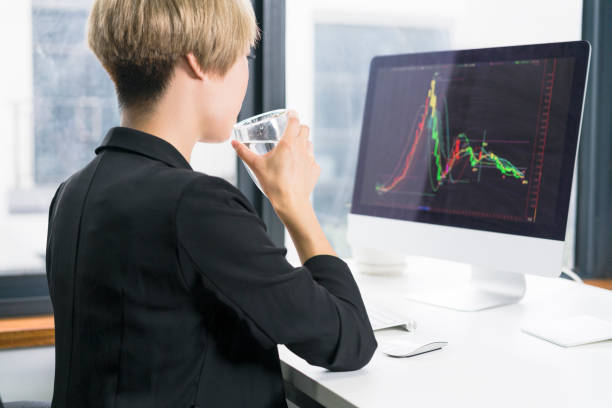 istock asian businesswoman looking at computer screen and drinking water 897880426