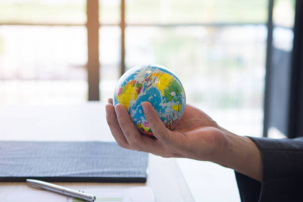 istock Businessman holding the global 897880564