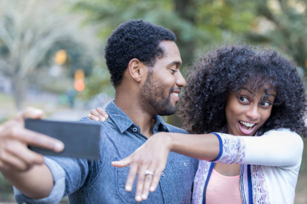 istock Excited young woman shows off engagement ring 897885560