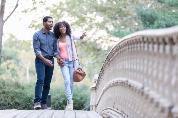 istock Young couple take a walk in city park 897885590