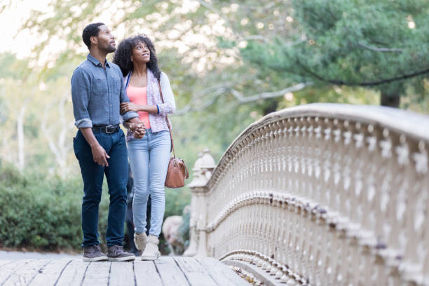 istock Attractive young couple walk in Central Park 897885602