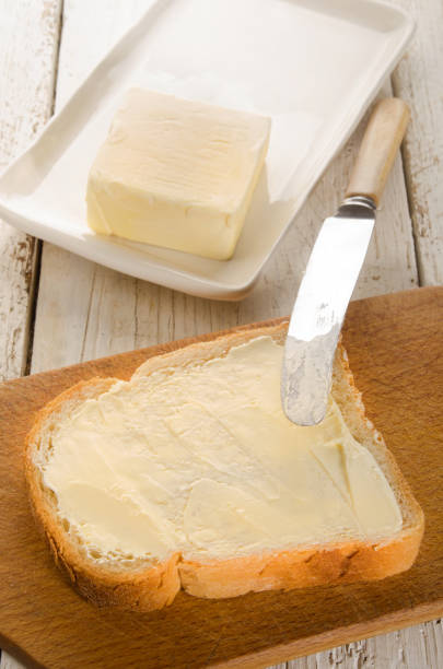istock slice bread with butter on wooden board 897895694