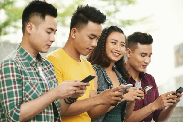 istock Cheerful young people with smartphones 897895726
