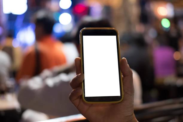 istock hand holding smartphone in pub. mobile phone with blank screen in restaurant 897896026