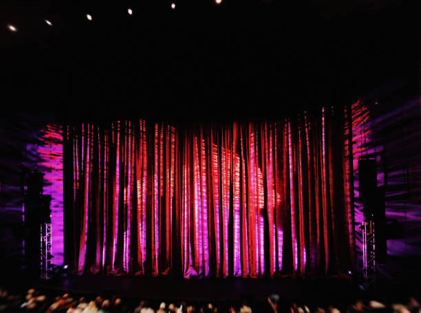 istock Theatre stage brightly lit just before curtain goes up 897915418