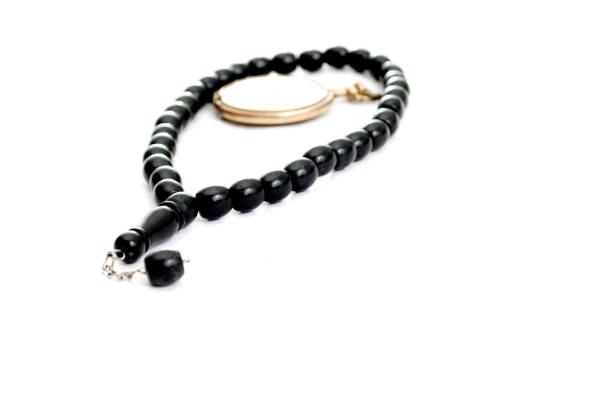 istock prayer beads and vintage pocket clock,time for praying 897920588