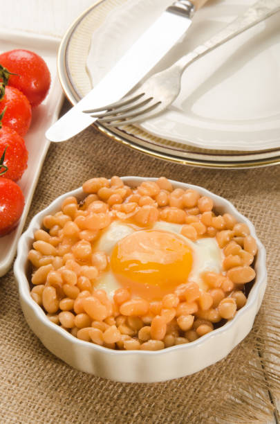istock baked beans with fried egg in a round serving plate 897928516