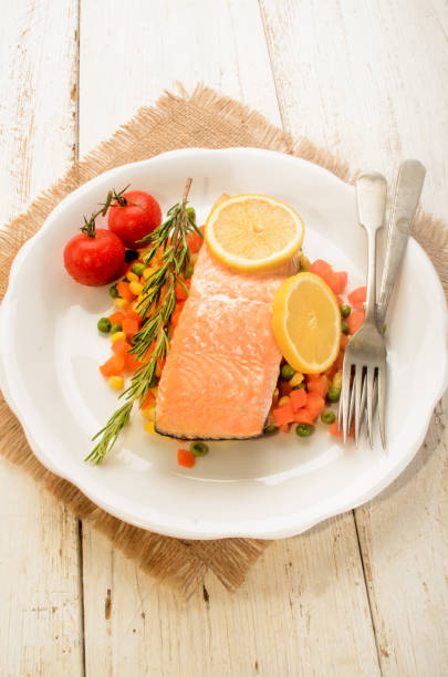 istock steamed salmon fillet on finely chopped vegetable 897928572
