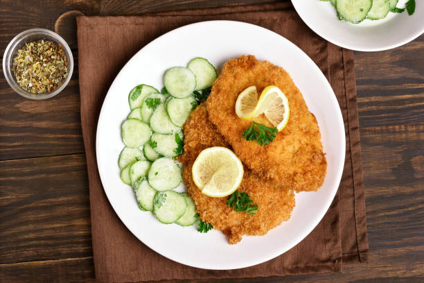 istock Tasty schnitzel with cucumber salad 897933280