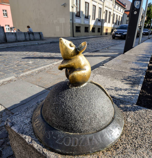 Klaipeda, Lithuania - August 16, 2017: Beautiful little magic mouse, Klaipeda, Lithuania. One of Klaipeda's charming, small street sculptures Golden Mouse