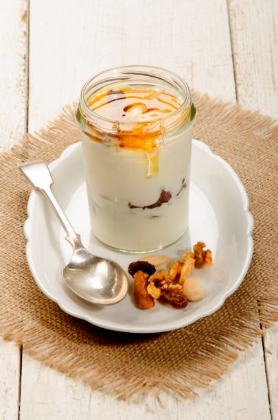 istock kefir in a glass with sweet honey, nuts and fruit 897936628