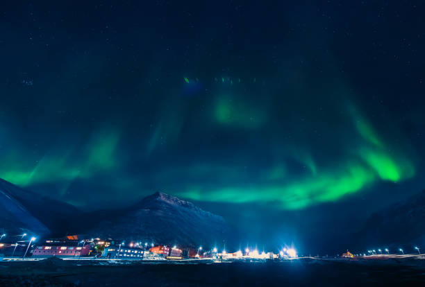 The polar arctic Northern lights aurora borealis sky star in Norway Svalbard in Longyearbyen city the moon mountains The polar arctic Northern lights aurora borealis sky star in Norway Svalbard in Longyearbyen city the moon mountains star sky night island stock pictures, royalty-free photos & images